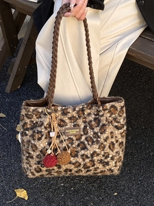 Women leopard print plush tote bag with woven chain handle and decorative charms
