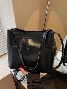 Fashionable black oil-wax leather bucket bag with top handle and stylish logo detail
