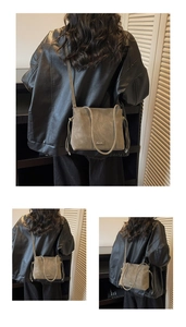 Detail of retro leather shoulder bag with drawstring tassels and metal logo on a model