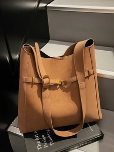 Retro large capacity dark camel suede tote bag for women commuting shown on a design book