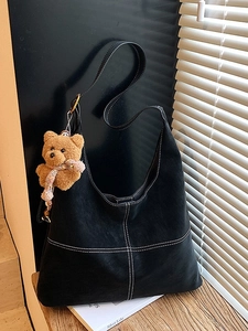 Retro black tote bag with white contrast stitching and a cute bear keychain charm