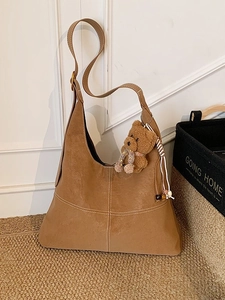 Vintage brown suede hobo bag with white stitching and bear charm for daily commute