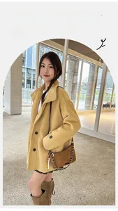 Close-up of ginger yellow wool blend coat featuring classic lapels and black buttons
