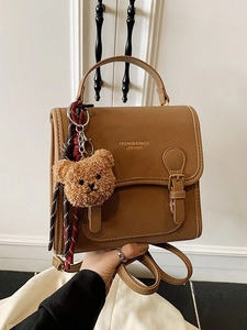 Brown vintage PU leather backpack with top handle and cute plush bear charm decoration