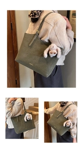 Detail of green suede tote bag with adjustable strap and cute rabbit doll ornament