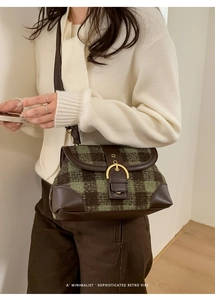 Detail of vintage green plaid shoulder bag with dark brown leather trim and golden buckle