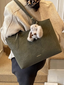 Retro dark green suede tote bag with plush bunny charm and adjustable leather strap