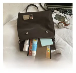 Interior view showing large capacity for laptop, tablet, and cosmetics in brown tote bag