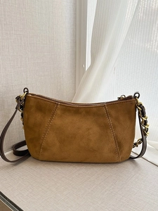 Vintage caramel suede shoulder bag with gold chain strap and curved zipper design