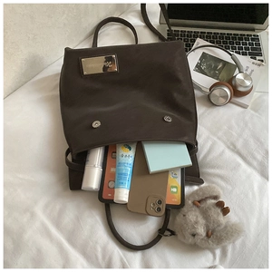 Detail showing the large storage capacity of this dark brown leather commuter backpack