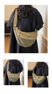 Detail of army green nylon crescent bag with wide shoulder strap and woven zipper pullers