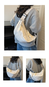 Detail of minimalist cream crescent crossbody bag with adjustable strap and textured nylon
