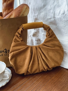 Vintage caramel suede crescent bag with elegant pleated design and smooth handle detail