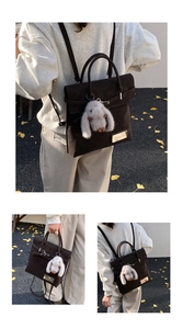 Detail of dark brown retro backpack showing texture, gold buckle, and plush rabbit charm