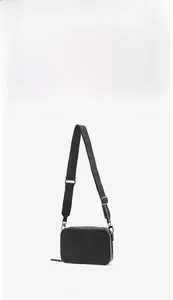 Front view detail of minimalist black leather mini envelope bag with silver hardware