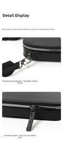 Detail of durable silver hooks and zipper on a black leather rectangular crossbody bag