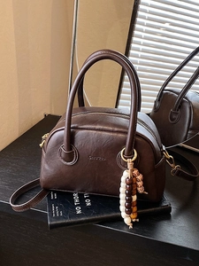 Retro chocolate brown bowling bag with double handles and decorative beaded charm