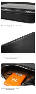Detail of leather bag showing silver metal zipper, neat stitching and brown inner pocket