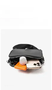 Capacity display of minimalist leather shoulder bag showing daily essentials inside