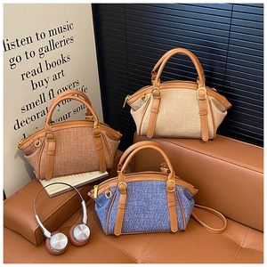 Three elegant vintage boston bags in beige, brown, and blue on a premium leather sofa