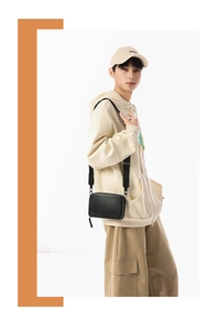 Close-up of a minimalist black leather rectangular crossbody bag for casual styling
