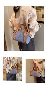 Detail of vintage Boston bag with blue woven texture and brown leather accents