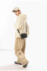 Minimalist black rectangular crossbody bag shown on model for size and style reference