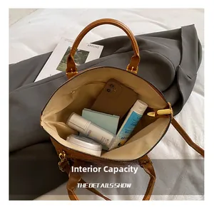 Detail view of the brown leather bag interior showing large capacity for essentials