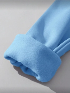 Close-up of sky blue sweatshirt cuffs featuring thick fleece lining and soft knit texture