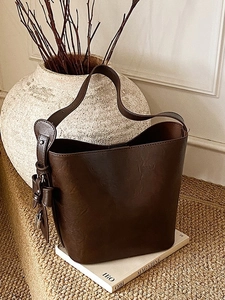 Retro dark brown large tote bag with textured leather and bow detail in a lifestyle setting