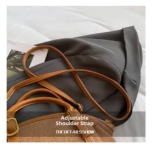 Detail showing adjustable leather strap with vintage metal buckle on woven bag