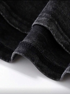 Close-up of vintage washed dark gray cotton T-shirt showing detailed hem stitching
