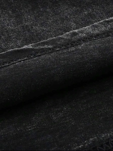 Detailed macro view of vintage washed charcoal fabric with durable double-stitch hem sewing