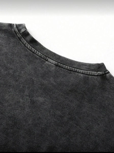 Detail shot of ribbed crew neck collar and vintage washed cotton fabric on dark grey t-shirt
