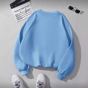 Relaxed fit light blue crewneck sweatshirt featuring drop shoulders and ribbed cuffs