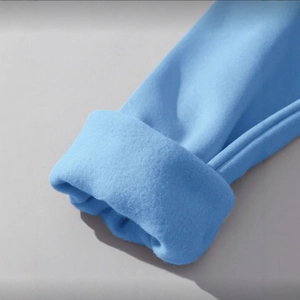 Light blue crewneck sweatshirt featuring ribbed cuffs and warm fleece lining detail