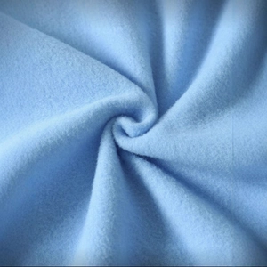 Soft baby blue fleece fabric texture with a plush spiral fold for cozy winter apparel