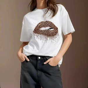 Women's casual white T-shirt featuring a leopard print lip graphic and black denim jeans