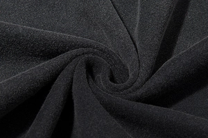 Macro shot of black cotton fabric detail with soft washed texture on high street t-shirt