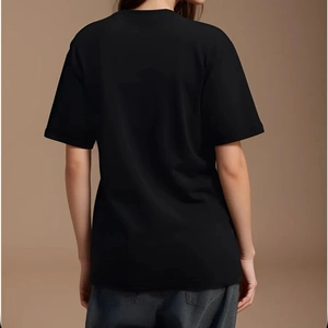 Back view of a casual black crew neck short sleeve t-shirt paired with dark grey jeans