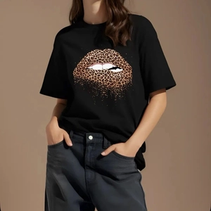Detail of leopard print red lips graphic on a black crew neck short sleeve cotton T-shirt