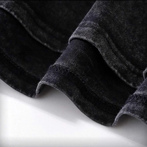 Oversize vintage washed t-shirt in dark grey showing hem details and dual stitching