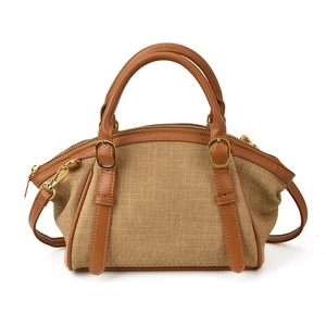 Vintage brown woven canvas crossbody bag with faux leather trim and golden metal hardware