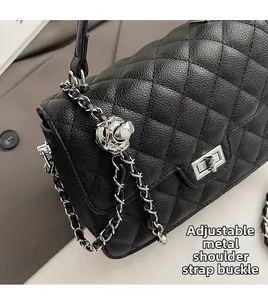 Detail of quilted leather bag featuring a silver flower adjustment buckle on the chain strap