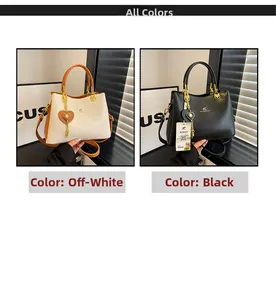 Detail of lychee pattern leather bags in beige and black with heart tassels and kangaroo logo