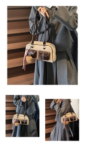 Detail of vintage beige and brown shoulder bag with metal buckles and plush bear charm