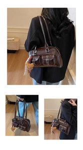 Detail of dark coffee leather tote bag featuring functional front pockets and a cute bear charm