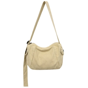 Sac bandoulière minimaliste en toile blanc cassé de forme croissant avec sangle