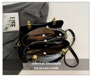 Internal view of the black handbag showing multi-layered compartments and striped lining