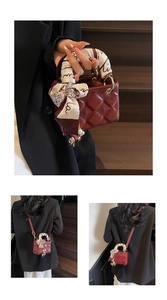 Detail of wine red quilted mini handbag with silk scarf handle and gold metal charms